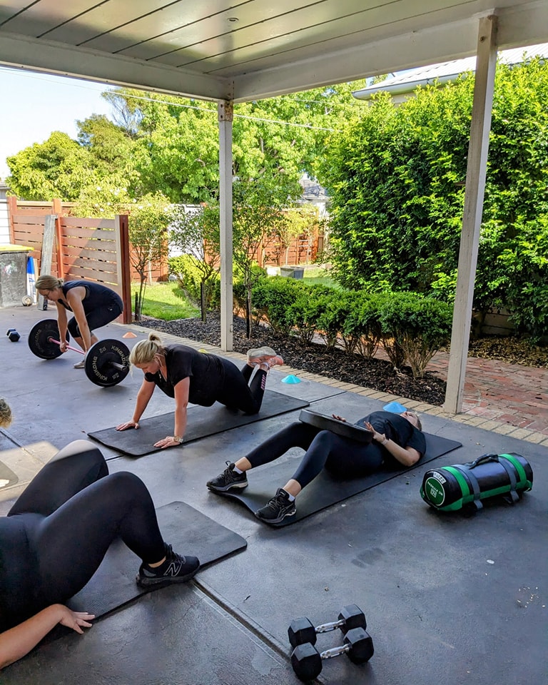 A group of women smiling after a fitness class